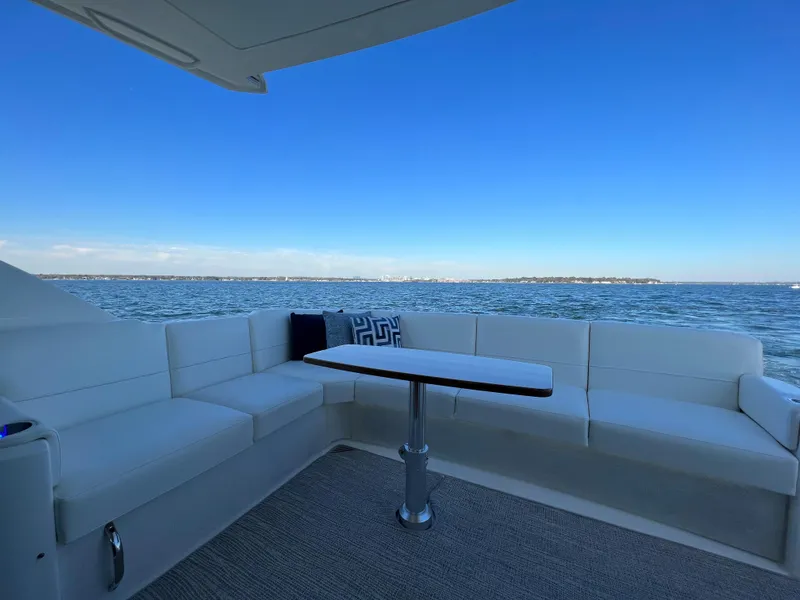 Slide: The Image of Luxurious seating area on 2021 Tiara Yachts C49 Coupe with ocean view. - 7