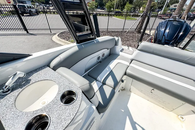 Slide: The Image of 2022 NauticStar 243 DC boat interior with seating and sink, showcasing luxury features. - 5