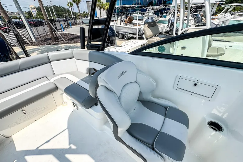 Slide: The Image of 2022 NauticStar 243 DC boat interior with gray and white seating. - 7