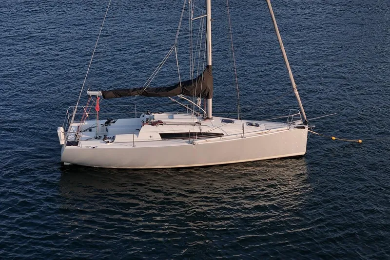 Slide: The Image of 2017 Jeanneau SunFast 3200 sailboat on calm water, side view. - 10