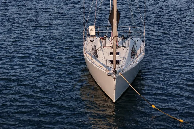 Slide: The Image of 2017 Jeanneau SunFast 3200 sailboat moored on calm blue water. - 11