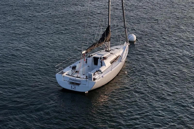 Slide: The Image of 2017 Jeanneau SunFast 3200 sailboat moored on calm water. - 13