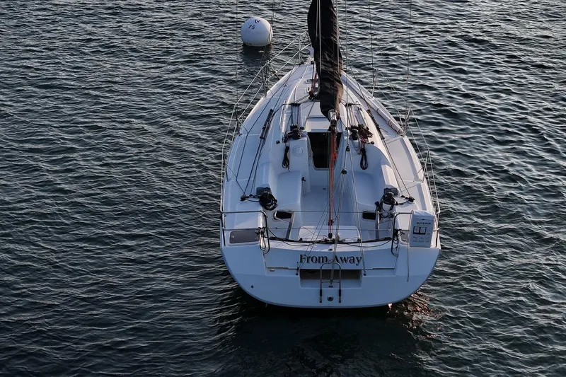 Slide: The Image of 2017 Jeanneau SunFast 3200 sailboat on calm water, viewed from above. - 14