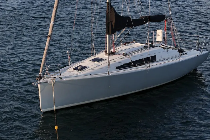 Slide: The Image of 2017 Jeanneau SunFast 3200 sailboat on calm water, featuring sleek design and modern rigging. - 16