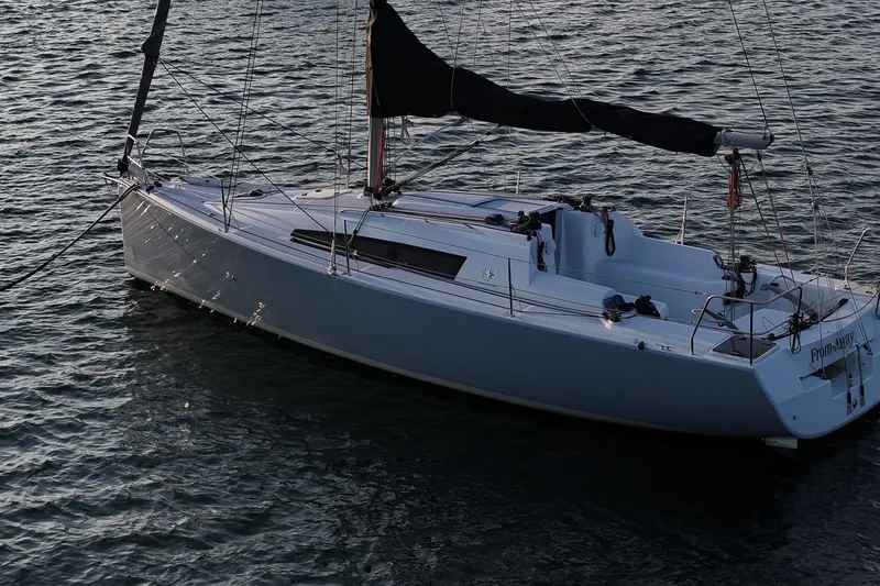 Slide: The Image of 2017 Jeanneau SunFast 3200 sailboat on calm water, side view. - 17