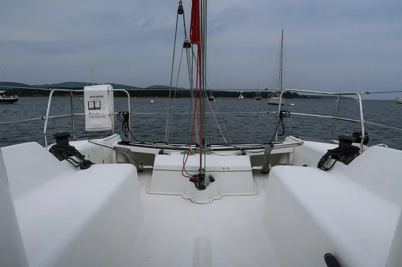 Slide: The Image of 2017 Jeanneau SunFast 3200 sailboat cockpit with winches, ropes, and scenic water view. - 19