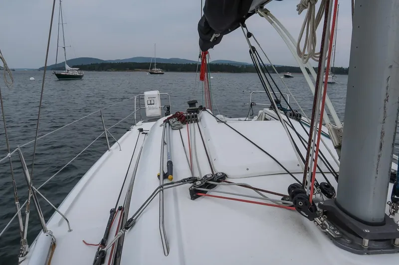 Slide: The Image of 2017 Jeanneau SunFast 3200 sailboat deck with rigging, anchored in calm waters. - 25