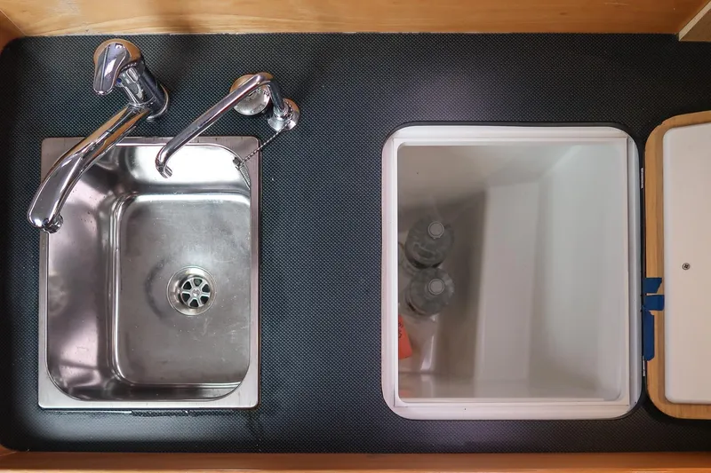 Slide: The Image of Stainless steel sink and storage compartment in 2017 Jeanneau SunFast 3200 yacht kitchen. - 31