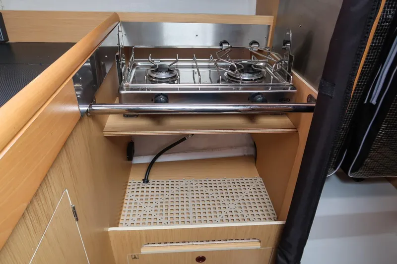 Slide: The Image of Compact kitchen area with a two-burner stove on a 2017 Jeanneau SunFast 3200 sailboat. - 32