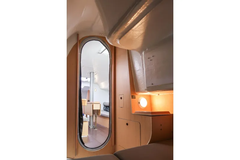 Slide: The Image of Interior of 2017 Jeanneau SunFast 3200 sailboat, featuring modern wood finish and oval mirror. - 41
