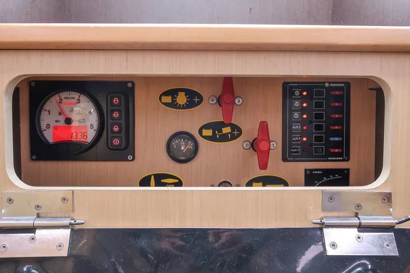 Slide: The Image of Control panel of a 2017 Jeanneau SunFast 3200 sailboat, featuring gauges and switches. - 44