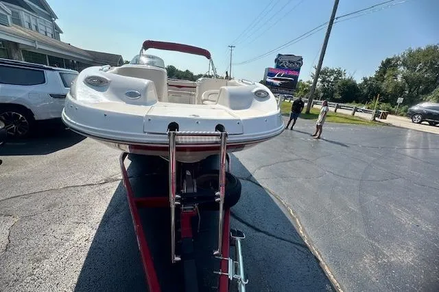 Slide: The Image of 2003 Chaparral Sunesta 222 boat on trailer in parking lot, sunny day. - 1