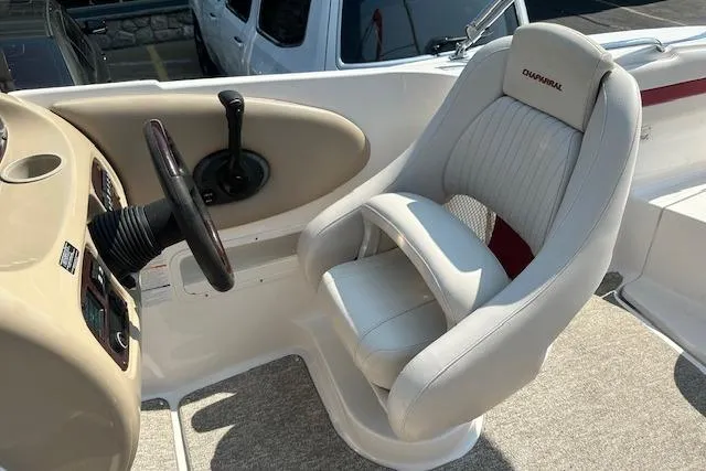 Slide: The Image of 2003 Chaparral Sunesta 222 boat interior with steering wheel and captain's chair. - 10