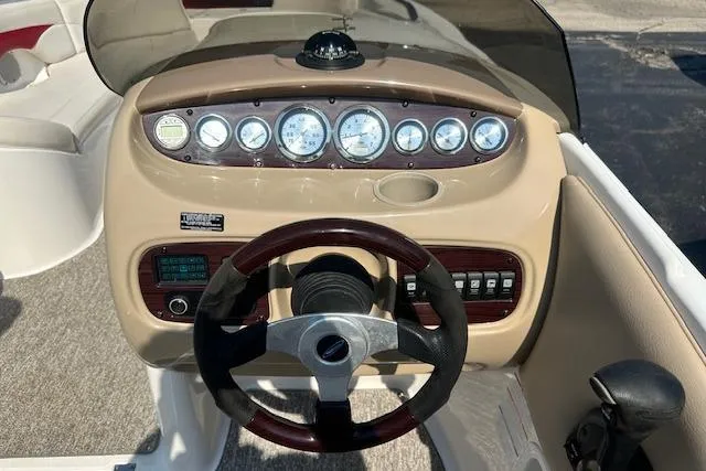 Slide: The Image of 2003 Chaparral Sunesta 222 boat dashboard with steering wheel and instrument panel. - 11
