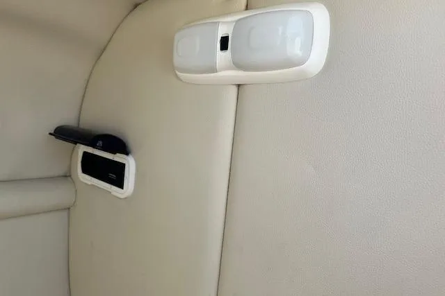 Slide: The Image of Interior detail of 2003 Chaparral Sunesta 222 boat, featuring beige upholstery and light fixtures. - 15