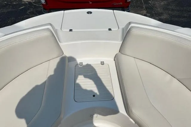 Slide: The Image of 2003 Chaparral Sunesta 222 boat interior with white seating and storage compartment. - 18