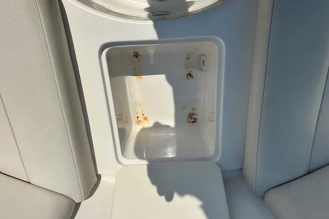 Slide: The Image of 2003 Chaparral Sunesta 222 boat storage compartment with rust stains. - 19