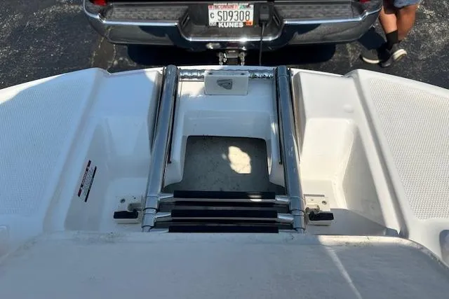 Slide: The Image of 2003 Chaparral Sunesta 222 boat ladder and swim platform, parked near a vehicle. - 20