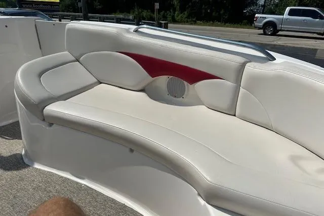 Slide: The Image of 2003 Chaparral Sunesta 222 boat interior with white and red cushioned seating. - 21