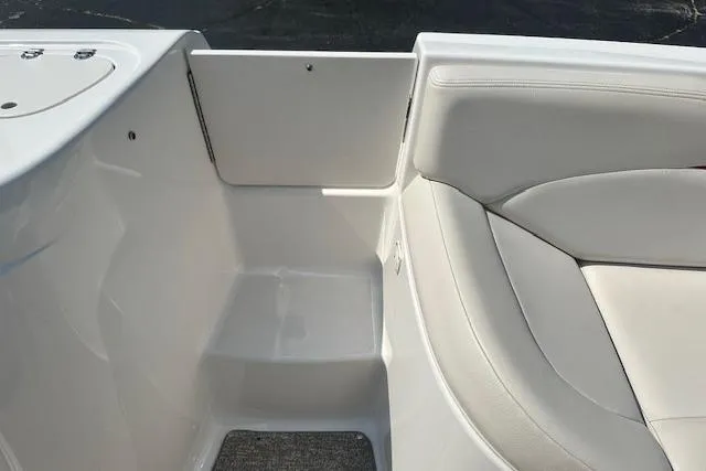 Slide: The Image of 2003 Chaparral Sunesta 222 boat interior with white seating and storage area. - 22