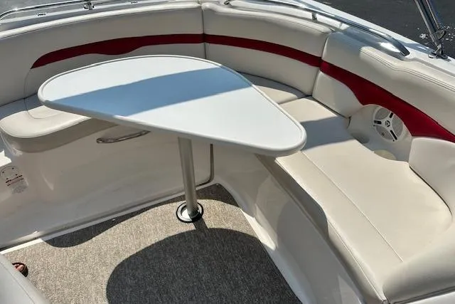 Slide: The Image of 2003 Chaparral Sunesta 222 boat interior with white seating and a triangular table. - 29