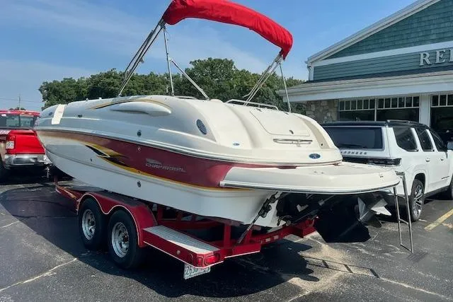 Slide: The Image of 2003 Chaparral Sunesta 222 boat on trailer with red canopy, parked in lot. - 3