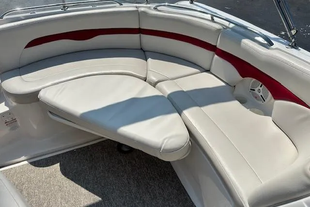 Slide: The Image of 2003 Chaparral Sunesta 222 boat interior with white and red cushioned seating. - 30