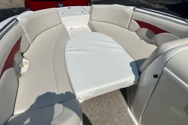Slide: The Image of 2003 Chaparral Sunesta 222 boat interior with beige seating and red accents. - 31