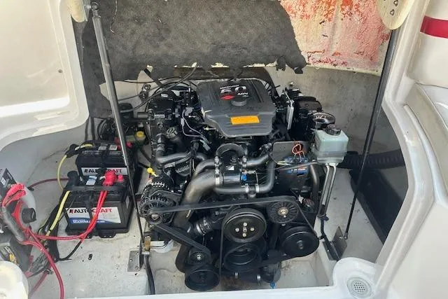 Slide: The Image of Engine compartment of a 2003 Chaparral Sunesta 222 boat, featuring a well-maintained motor. - 35