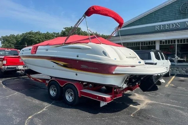 Slide: The Image of 2003 Chaparral Sunesta 222 boat on trailer with red cover, parked outside a building. - 37