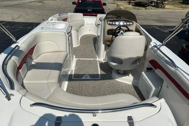 Slide: The Image of 2003 Chaparral Sunesta 222 boat interior with seating and helm, parked on a lot. - 7
