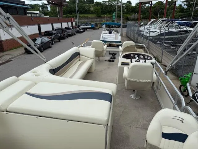 Slide: The Image of 2008 Bennington 2277FSi pontoon boat with spacious seating and steering console, docked at marina. - 19