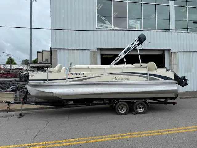 Slide: The Image of 2008 Bennington 2277FSi pontoon boat on trailer outside a warehouse. - 2