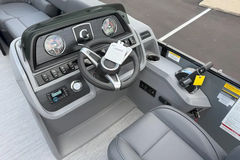 Slide: The Image of 2026 Godfrey SWEETWATER 2286 SFL boat dashboard with steering wheel and controls. - 12