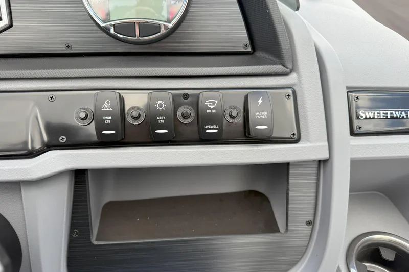 Slide: The Image of Control panel of 2026 Godfrey SWEETWATER 2286 SFL boat with labeled switches. - 15