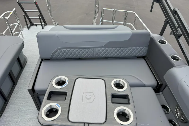 Slide: The Image of 2026 Godfrey SWEETWATER 2286 SFL boat interior with gray seating and cup holders. - 17