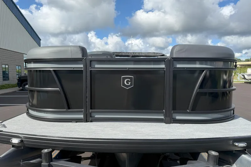 Slide: The Image of 2026 Godfrey SWEETWATER 2286 SFL pontoon boat, black exterior, parked outdoors under cloudy sky. - 5
