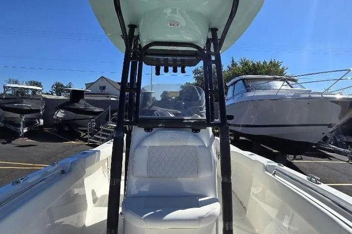 Slide: The Image of 2026 Key West 203 FS boat interior with seating and console, displayed outdoors. - 6