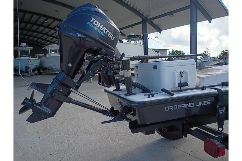 Slide: The Image of Trailer with Pelican Ambush boat, 2013 model, parked on concrete surface. - 3