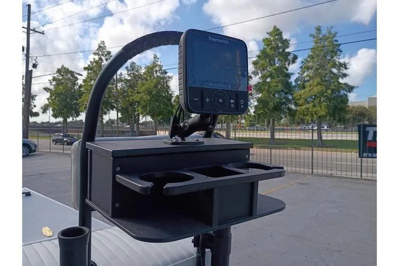 Slide: The Image of Pelican Ambush 2013 boat with Tohatsu outboard motor and fishing gear at a marina. - 7