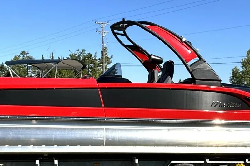 The Image of Red and black 2022 Manitou XT 27 SRW pontoon boat with sleek design. - 1