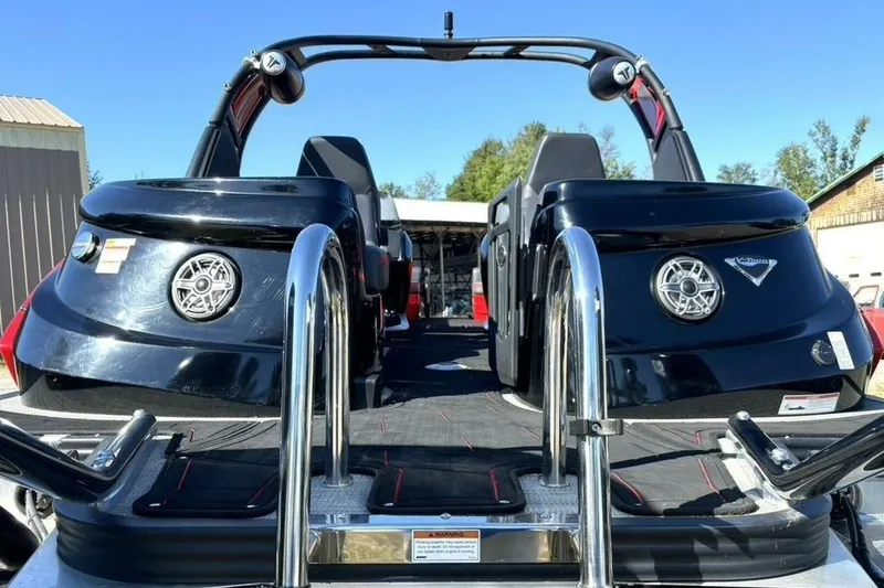 Slide: The Image of 2022 Manitou XT 27 SRW boat with sleek black design and chrome accents. - 11