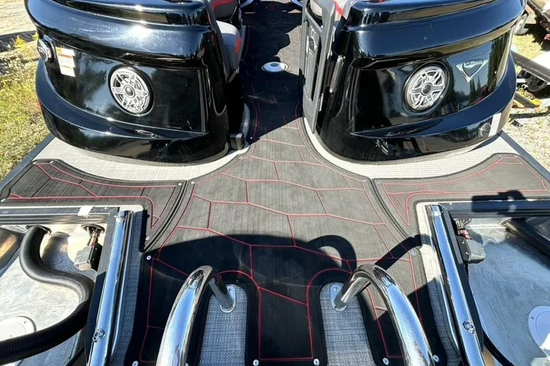 Slide: The Image of 2022 Manitou XT 27 SRW boat interior with sleek black design and modern features. - 12