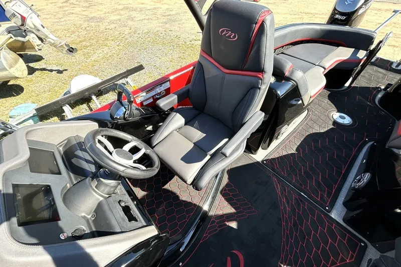 Slide: The Image of Interior of 2022 Manitou XT 27 SRW boat with steering wheel and seating. - 18