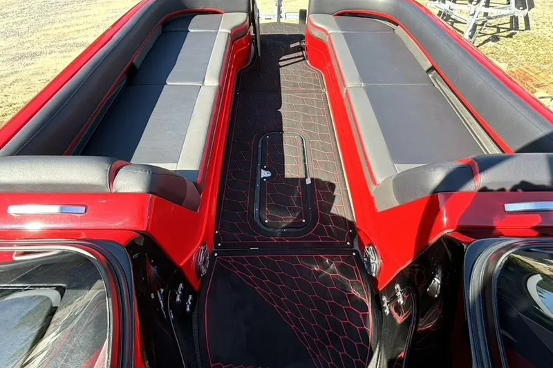 Slide: The Image of 2022 Manitou XT 27 SRW boat interior with red and black seating and flooring. - 24