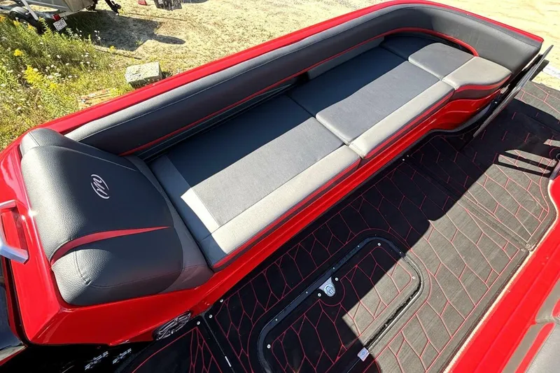 Slide: The Image of Red and black seating area of 2022 Manitou XT 27 SRW boat, featuring sleek design. - 25