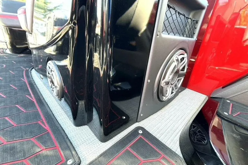 Slide: The Image of 2022 Manitou XT 27 SRW interior with sleek black and red design, featuring built-in speakers. - 30