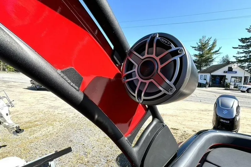 Slide: The Image of 2022 Manitou XT 27 SRW boat with mounted speaker, red and black design. - 31
