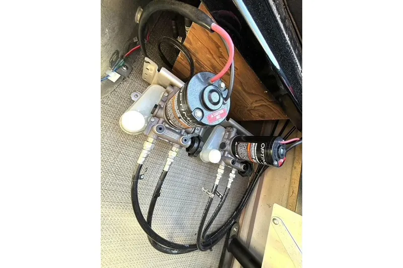 Slide: The Image of Hydraulic system components of a 2022 Manitou XT 27 SRW, featuring hoses and connectors. - 35