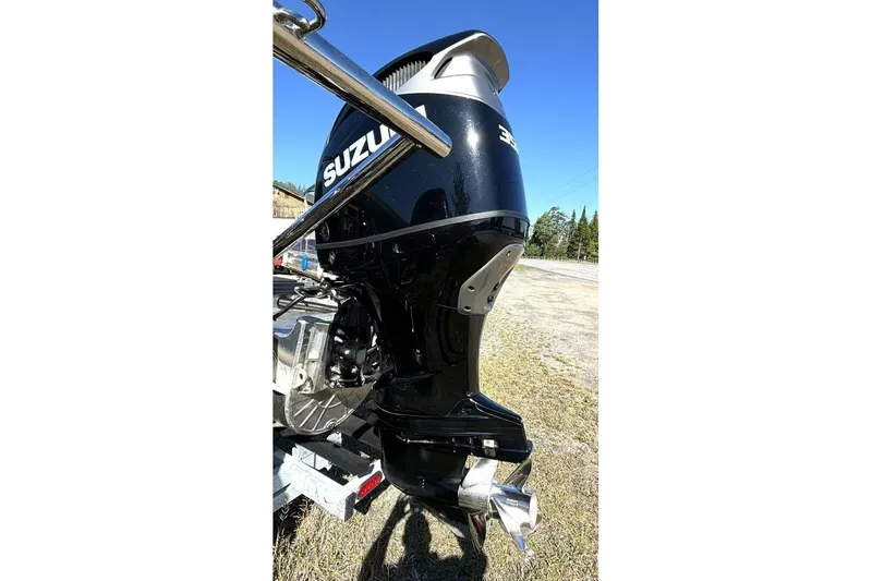 Slide: The Image of 2022 Manitou XT 27 SRW with Suzuki outboard motor in a sunny outdoor setting. - 36